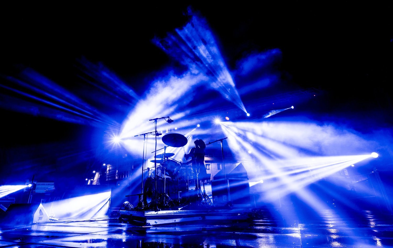 Live musicians performing under stage lighting